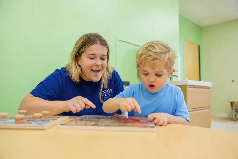 Therapist and child working together on learning activity